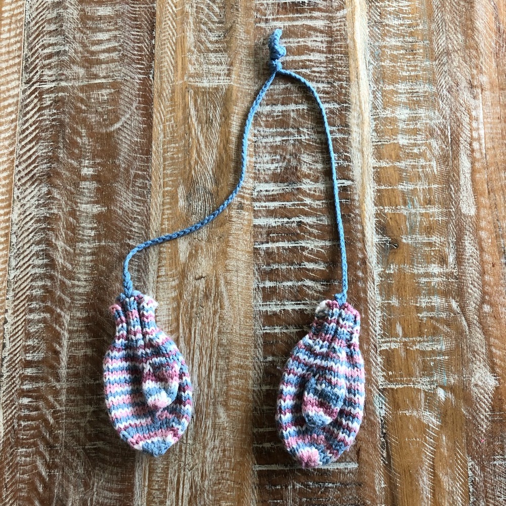 Handmade knit mittens on a string for babies and toddlers
